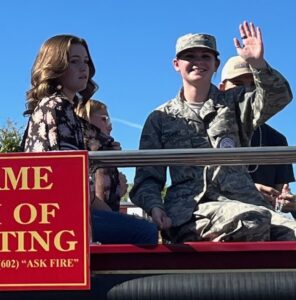 Basha High School Student and 2022 Essay Competition Winner Ryann Terrell rides aboard the Hall of Flame Fire Truck in the 2022 Phoenix Veterans Day Parade.